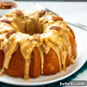 Bundt Cake covered with praline sauce on large white serving platter.