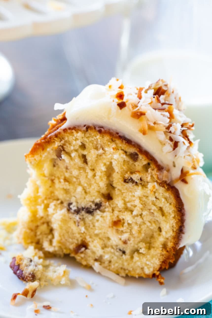 Decadent Italian Cream Bundt Cake 4 A delicious slice of Italian Cream Bundt Cake served on a white plate, showcasing its rich texture and glaze.