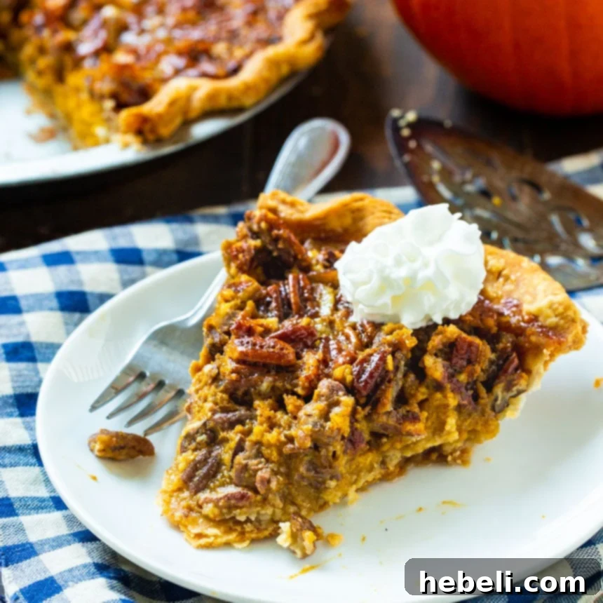 Golden Pecan Pumpkin Dream 2 Slice of Pumpkin Pecan Pie on a white plate with whipped cream, ready to be enjoyed.