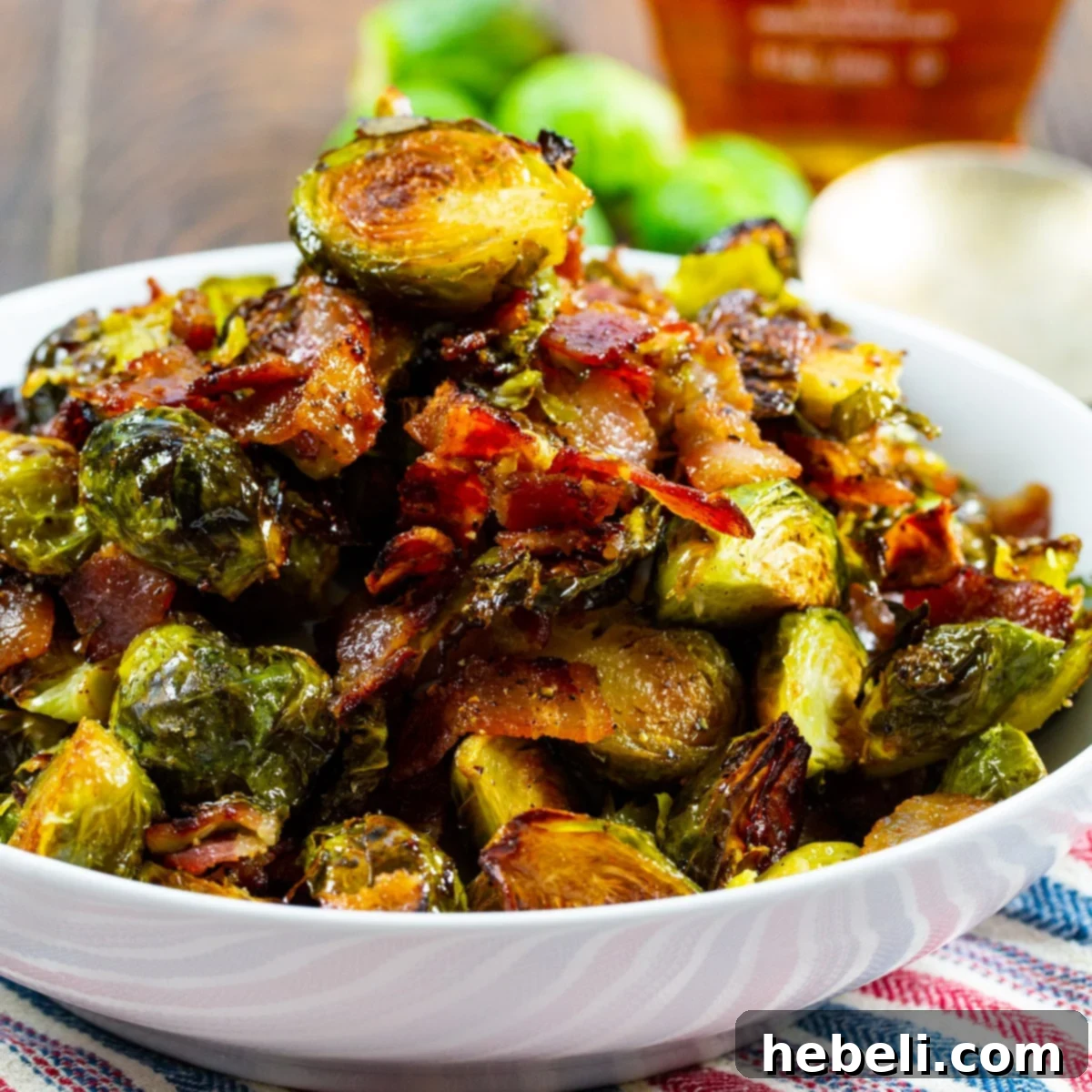 Sweet and Savory Maple Bacon Brussels Sprouts 2 Maple Bacon Brussels Sprouts served in an elegant white bowl, showcasing their golden-brown caramelization and crispy bacon bits.