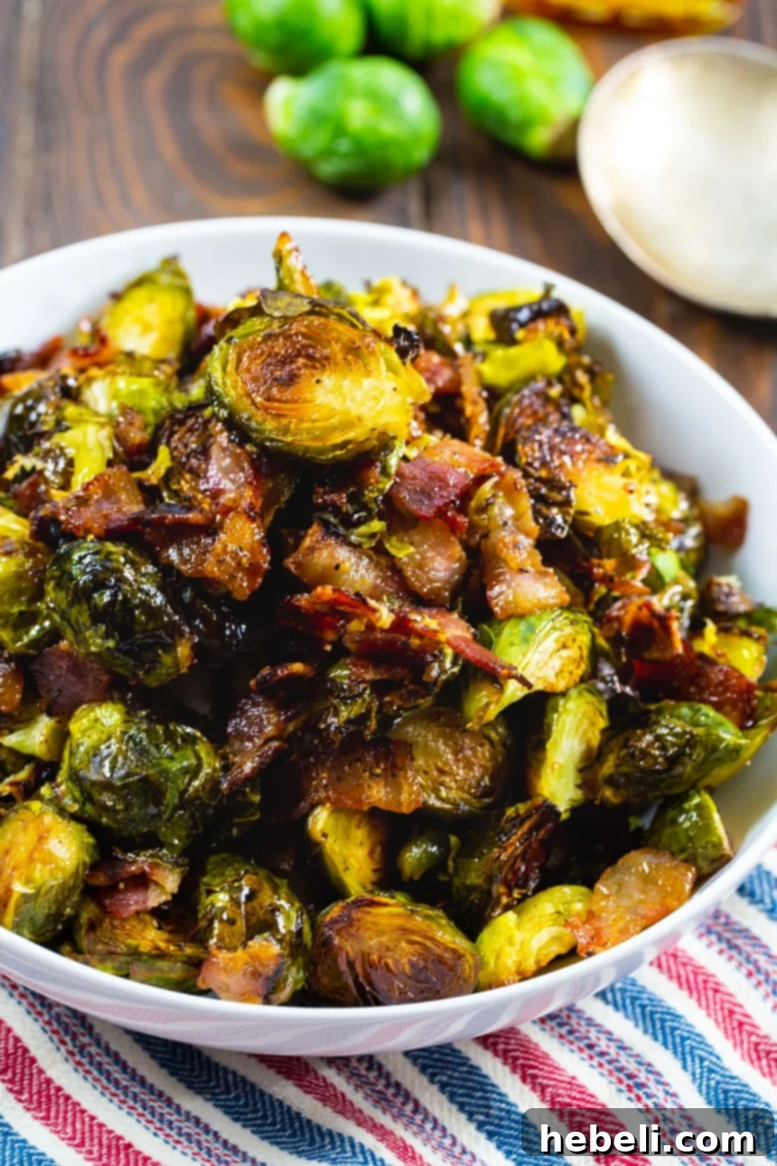 Sweet and Savory Maple Bacon Brussels Sprouts 4 Close-up of golden-brown Maple Bacon Brussels Sprouts in a white serving bowl, showing the crisp edges and bacon pieces.