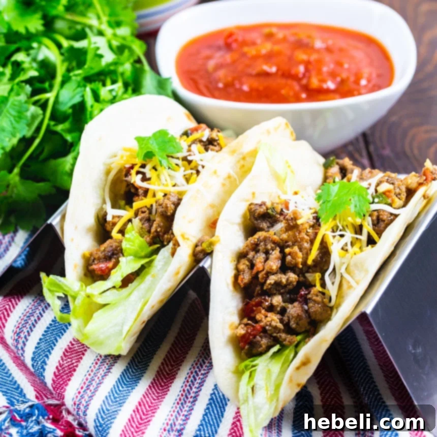 Your New Favorite Taco Meat 2 Two deliciously prepared tacos in soft flour tortillas, ready to be enjoyed.