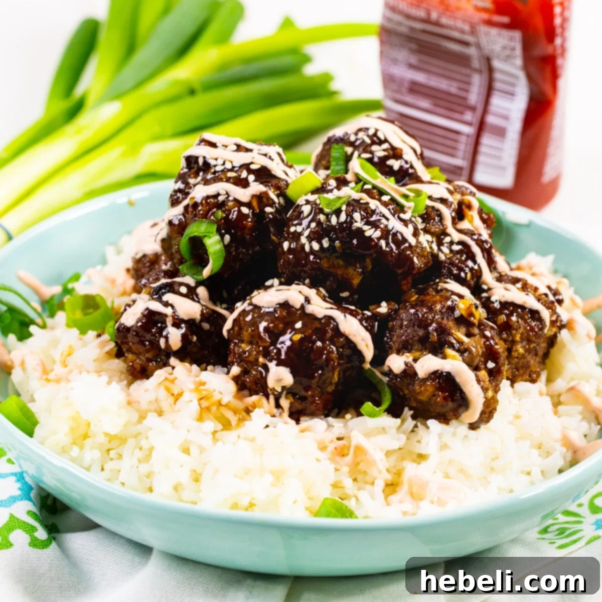 Effortless Korean Bulgogi Meatballs 2 Delicious Beef Bulgogi Meatballs served over fluffy white rice, ready to be enjoyed as a complete meal.
