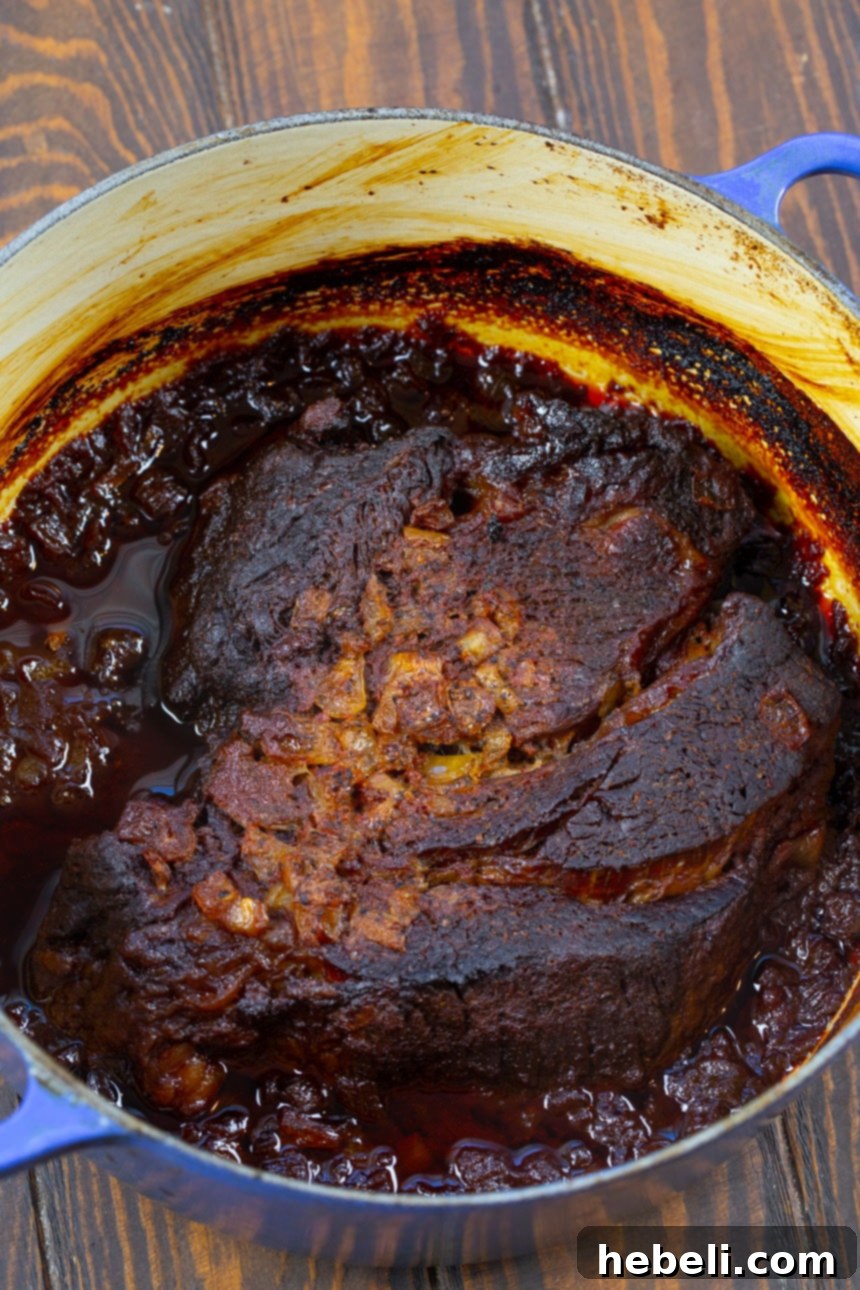 Smoky Pulled Beef 3 Boneless chuck roast searing in a Dutch oven before slow cooking.