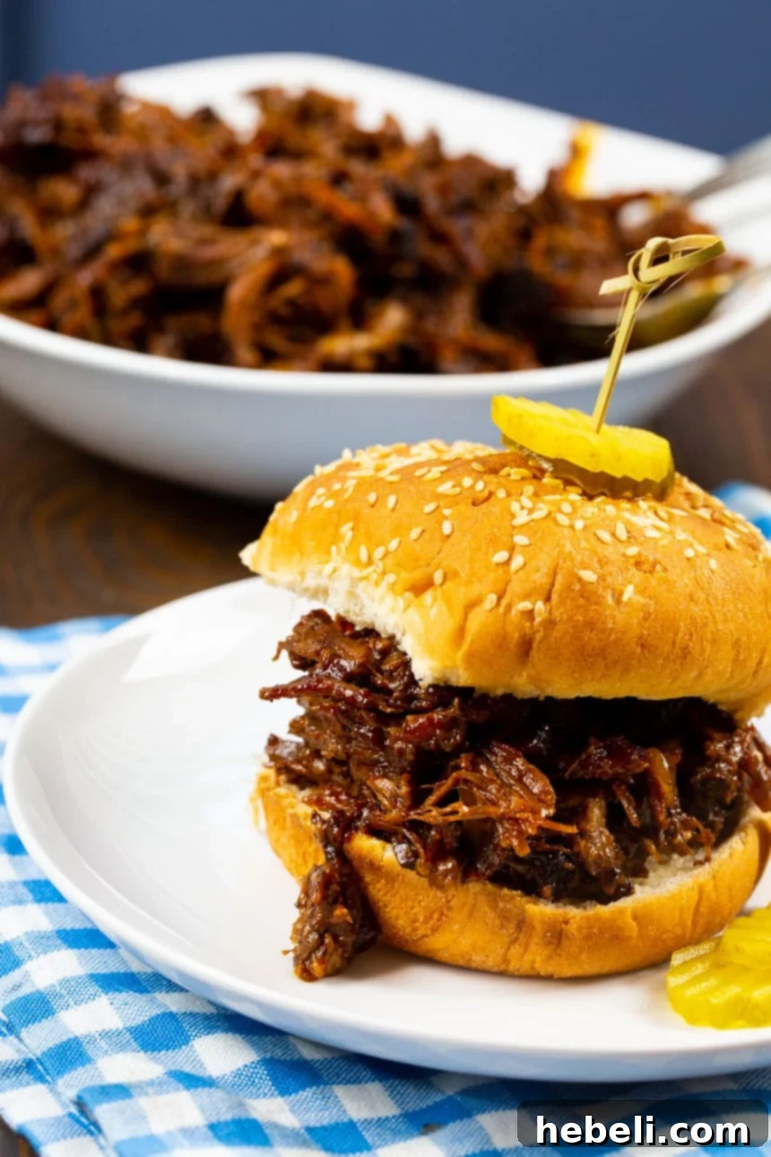 Smoky Pulled Beef 5 A BBQ Beef Sandwich with a bowl overflowing with shredded barbecued beef.