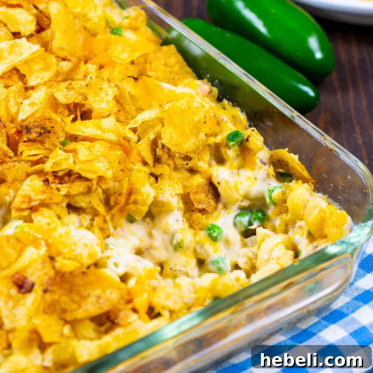 A golden-brown Jalapeño Tuna Noodle Casserole in a casserole dish, fresh from the oven, with a crispy, bubbly topping.