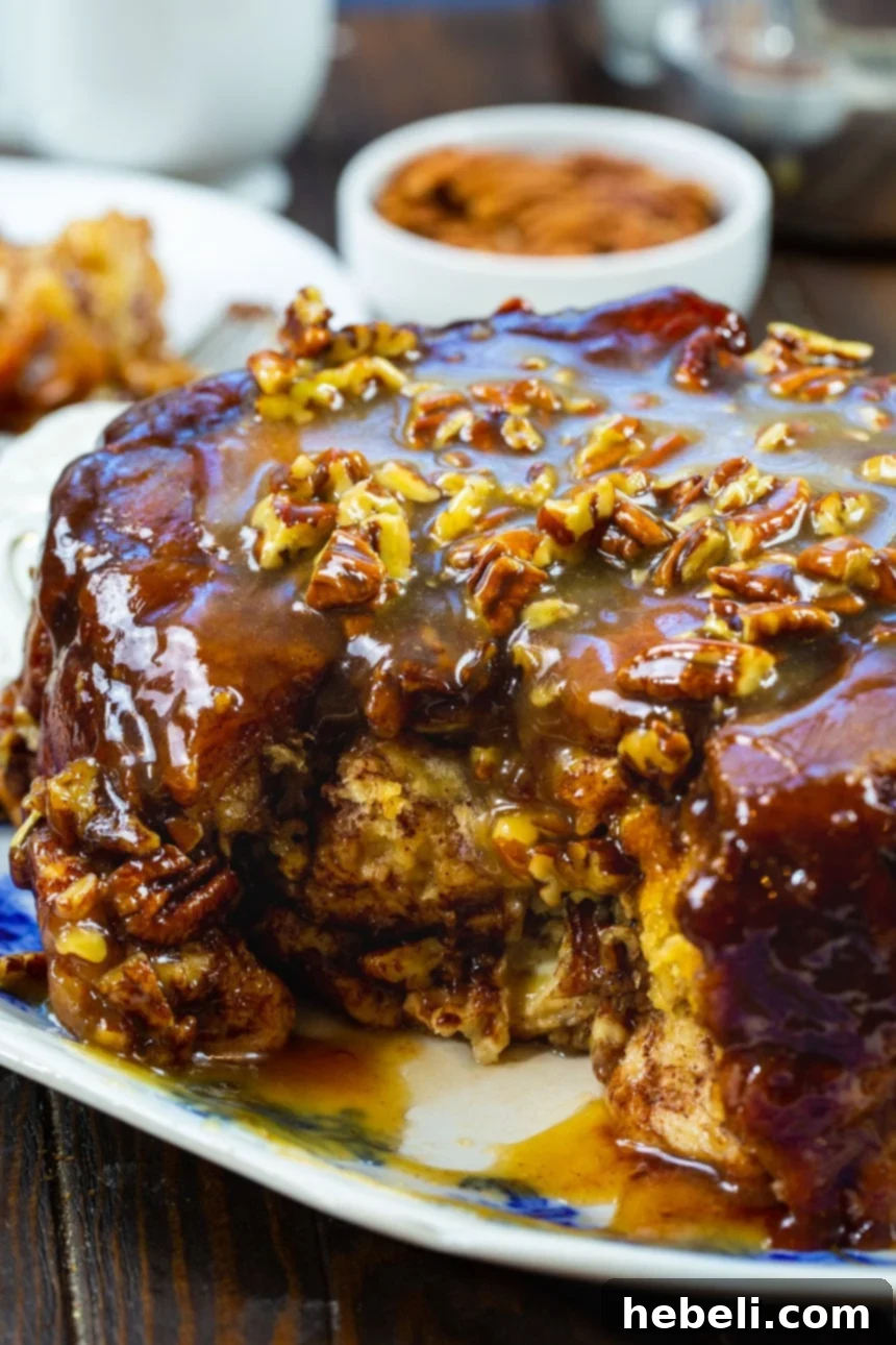 A slice of Slow Cooker Monkey Bread, revealing its gooey caramel center and pecans.