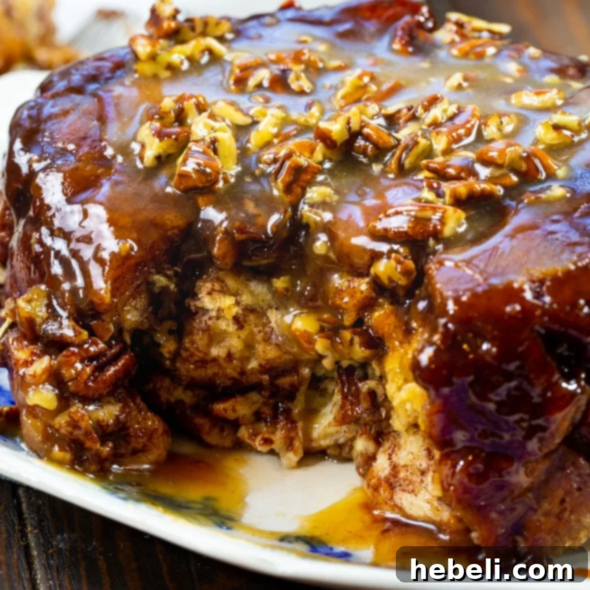 Close-up of Slow Cooker Monkey Bread with a rich caramel glaze and visible pecans.
