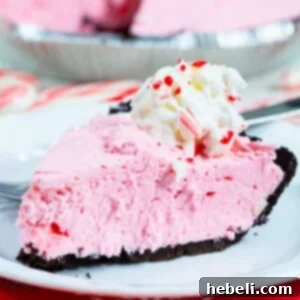 Slice of Peppermint Pie on a white plate, ready for serving.