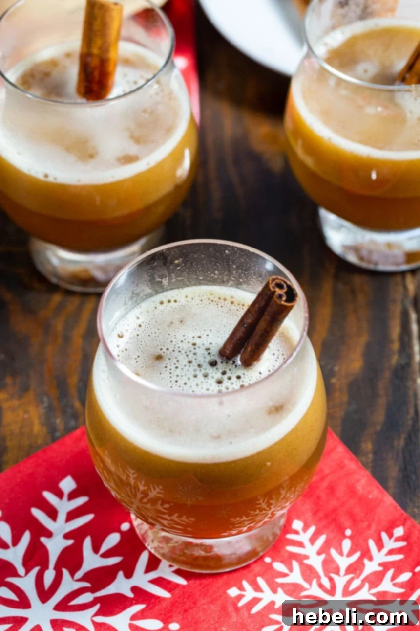 Three glasses of Hot Buttered Bourbon ready to be served, ideal for cold weather entertaining.