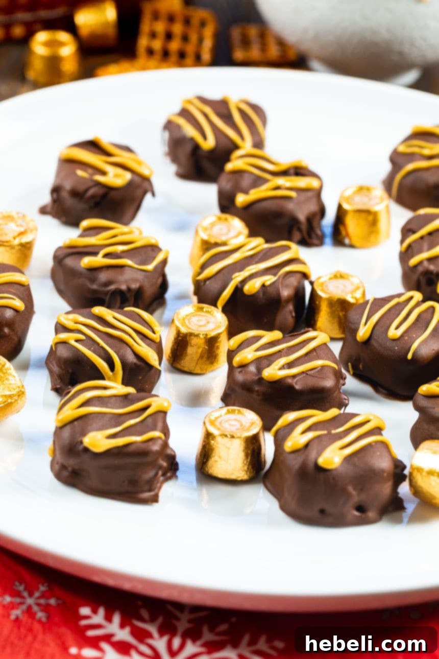 Sweet and Salty Rolo Pretzel Bites 3 Rolo Pretzel Sandwiches neatly arranged on a pristine white plate, showcasing their perfect shape and chocolate coating.