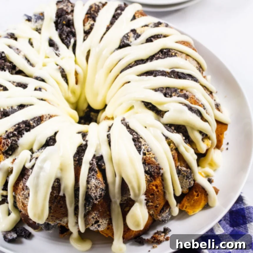 Whole Cookies and Cream Monkey Bread on a serving platter, showcasing its golden crust and delicious glaze.