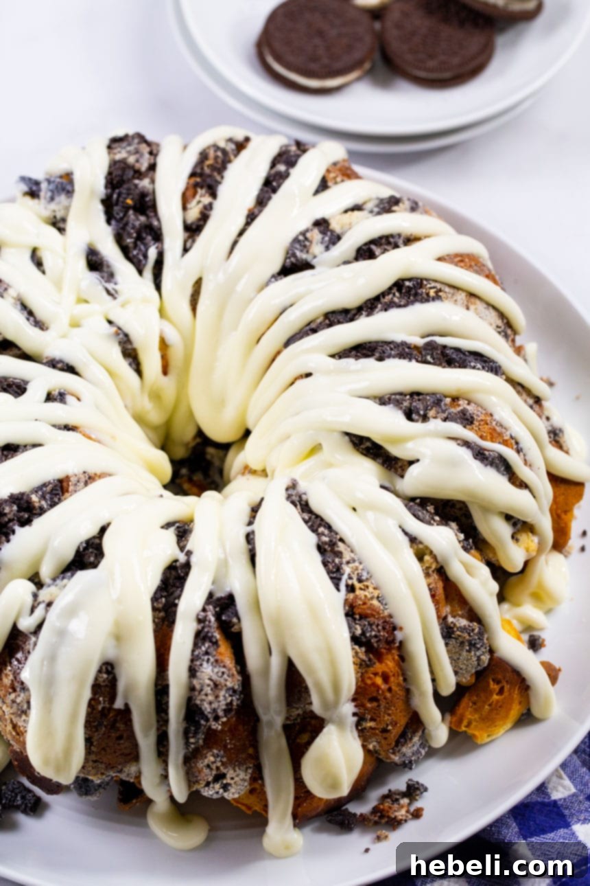 Monkey Bread covered in a generous cream cheese glaze on a serving platter, ready to be enjoyed.