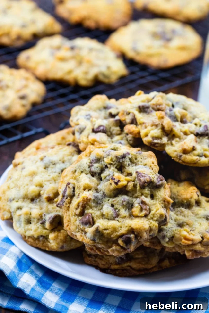 The Secret to DoubleTree's Signature Cookie 3 Warm DoubleTree Cookies cooling on a wire rack, with some already plated, highlighting fresh baking.
