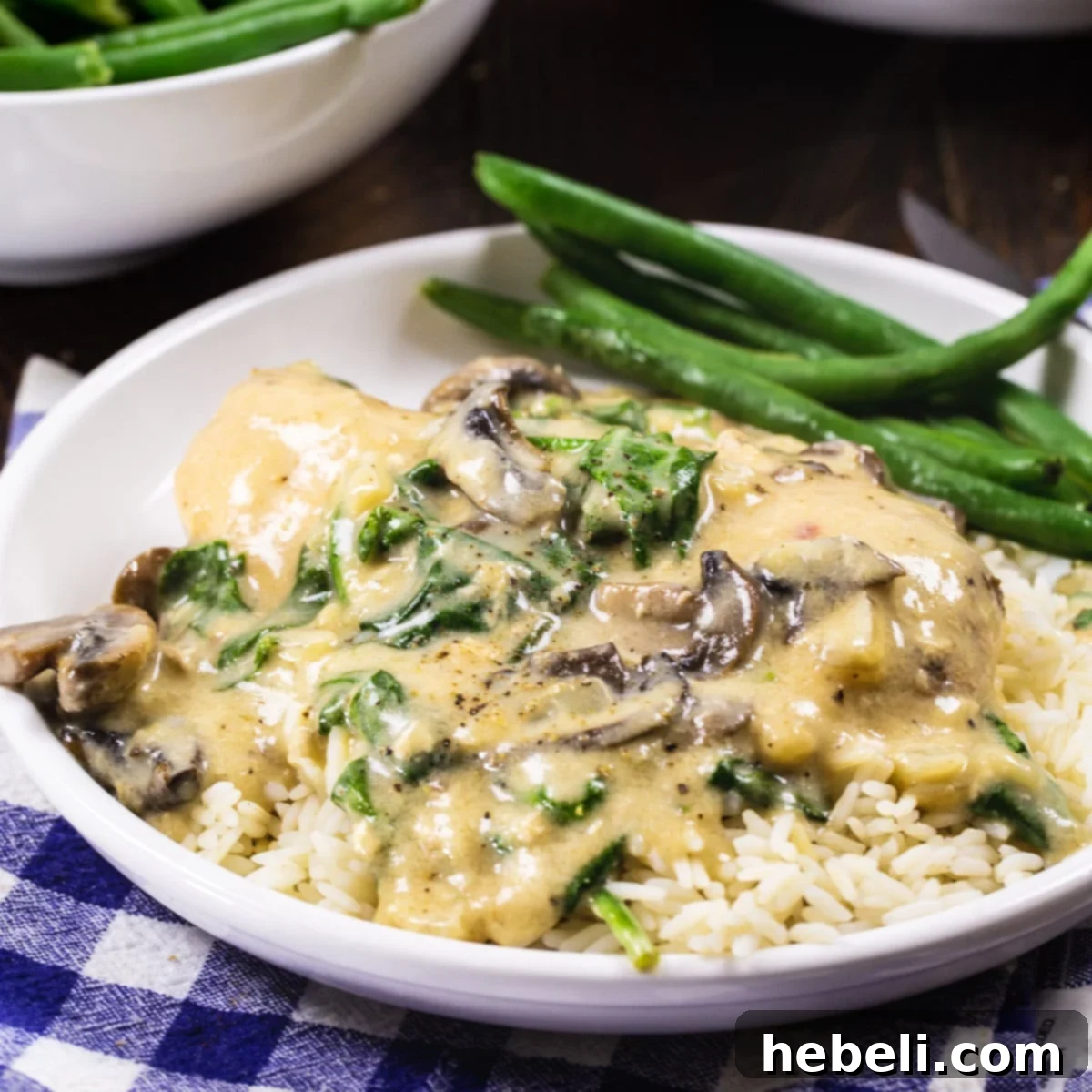 Garlic Parmesan Chicken served over white rice with green beans, showcasing the creamy sauce and tender chicken.