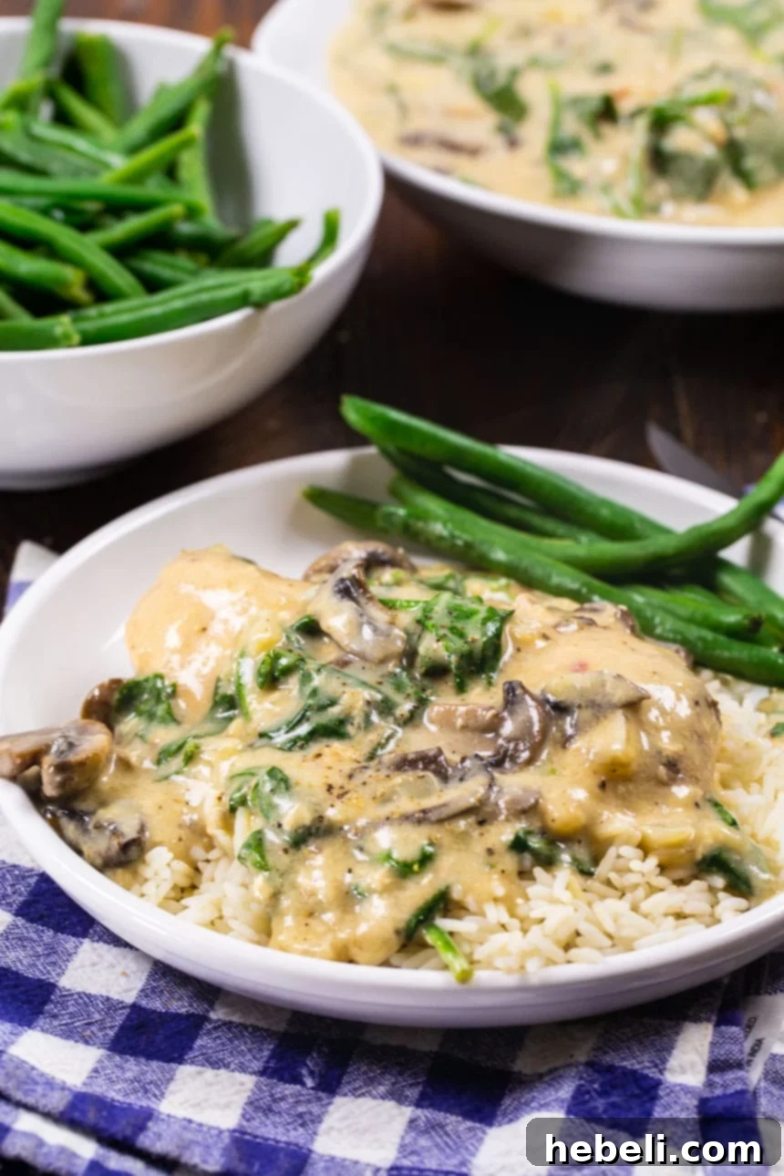 Slow Cooker Garlic Parmesan Chicken on a plate with steamed green beans, ready for a comforting meal.