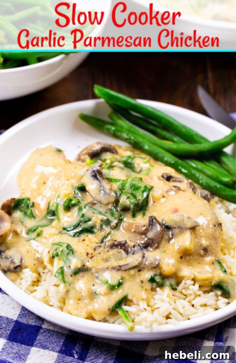 Close-up of Slow Cooker Garlic Parmesan Chicken with creamy sauce, fresh spinach, and mushrooms.