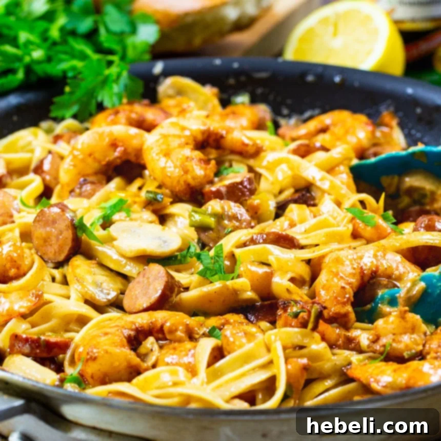 Mardi Gras Flavor Fiesta 2 Creamy Mardi Gras Pasta loaded with shrimp, andouille sausage, and vibrant peppers in a skillet.