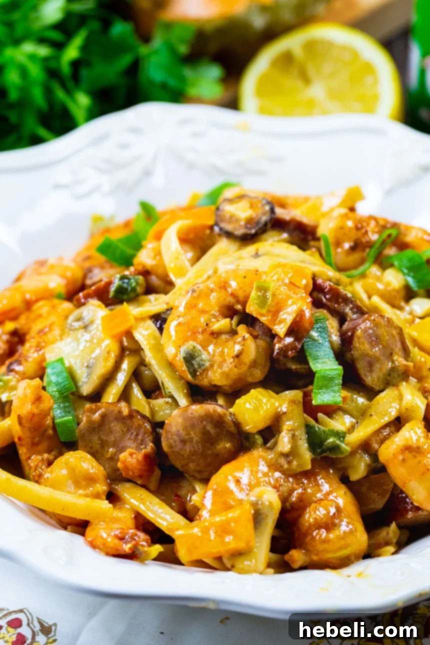 Mardi Gras Flavor Fiesta 4 Mardi Gras Pasta served in a white bowl, garnished with fresh parsley.