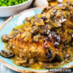 Roasted Pork Loin with Mushroom Gravy plated and sliced, ready to serve with sides.