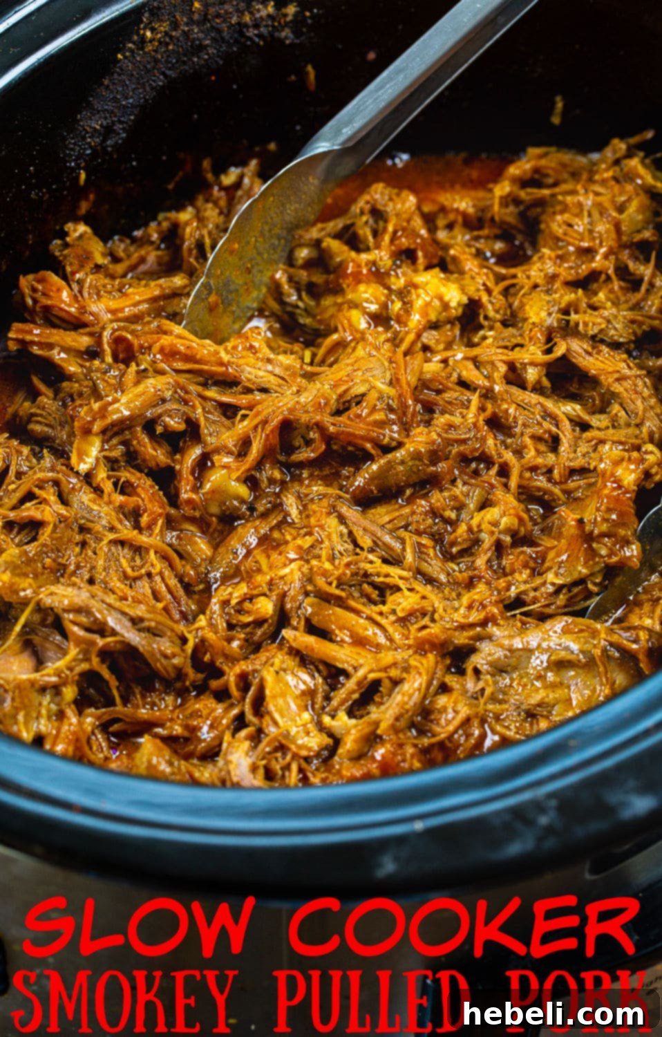 A generous serving of slow cooker smoky pulled pork, glistening with BBQ sauce, ready to be devoured.