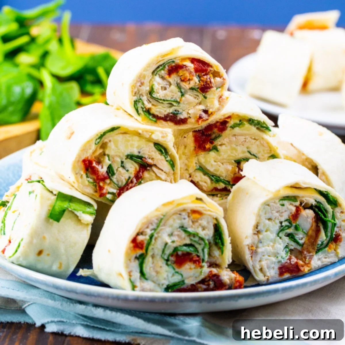 Creamy Tuscan Chicken Pinwheels 2 Tuscan Chicken Pinwheels piled up on a plate, showcasing their vibrant colors and appealing texture.