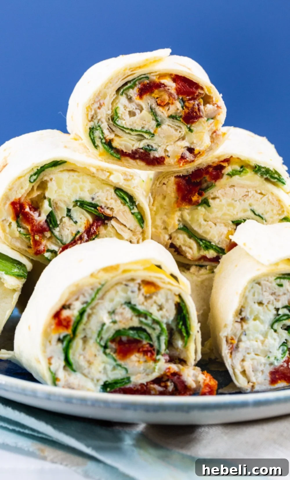 Creamy Tuscan Chicken Pinwheels 4 Beautifully arranged Tuscan Chicken Pinwheels on a platter, ready to be served.
