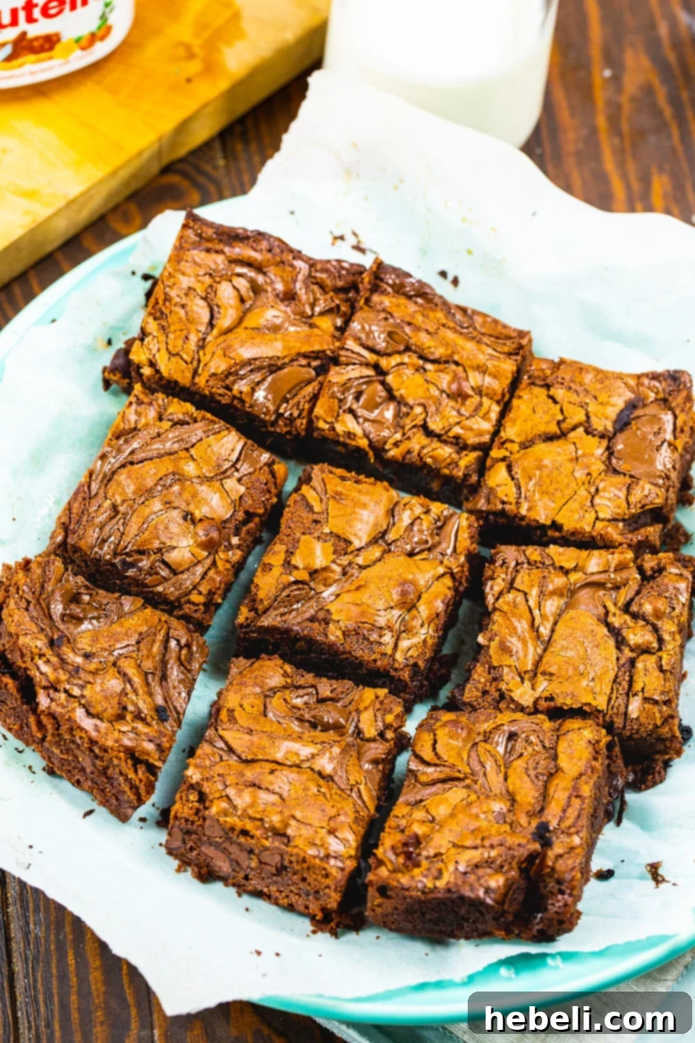 Close-up of freshly baked Nutella Brownies cut into neat squares, showing the moist, fudgy interior and visible chocolate chips.