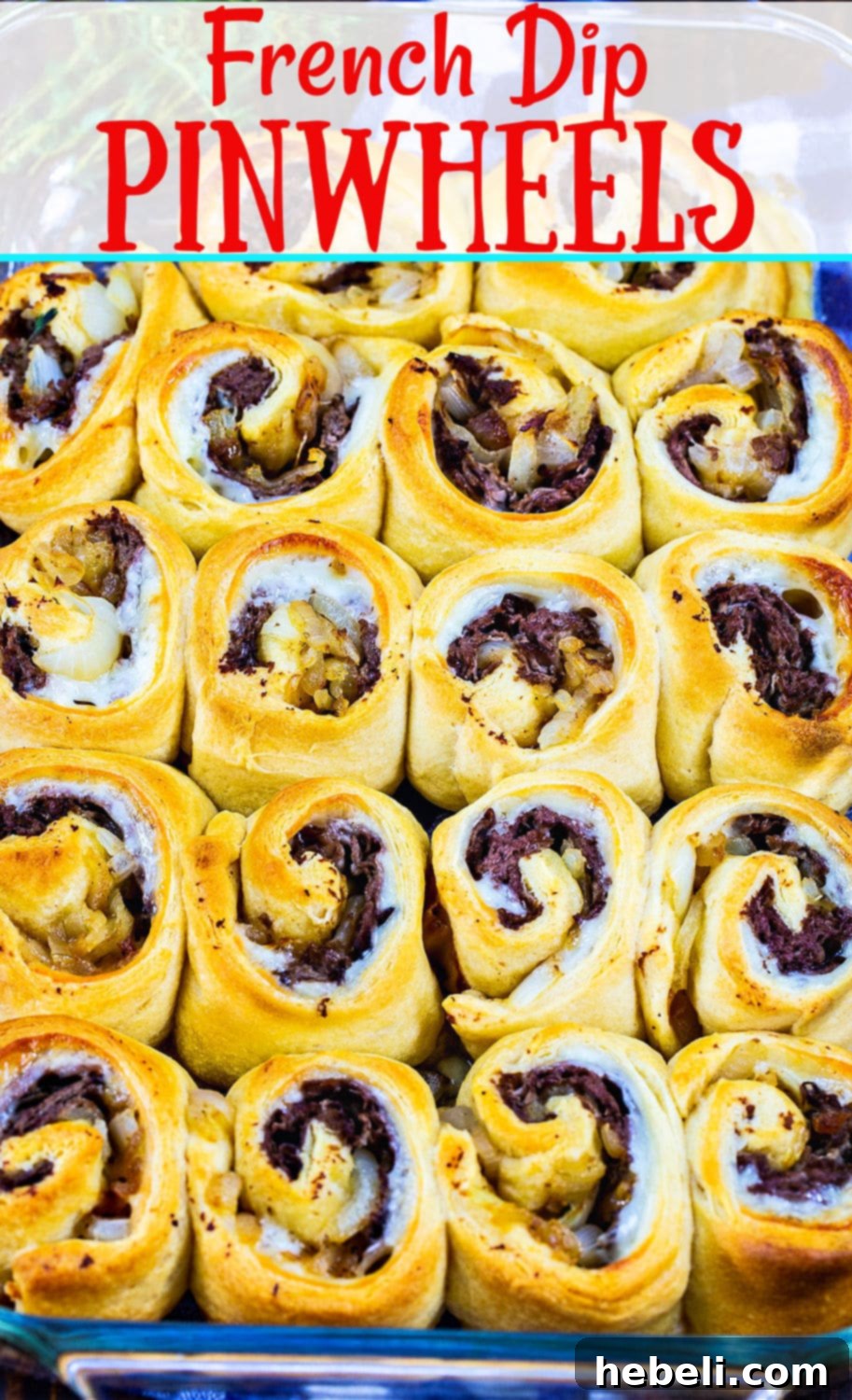 Flavorful French Dip Roll-Ups 7 Close-up of golden-brown French Dip Pinwheels in a baking dish, showcasing their flaky crust and savory filling.
