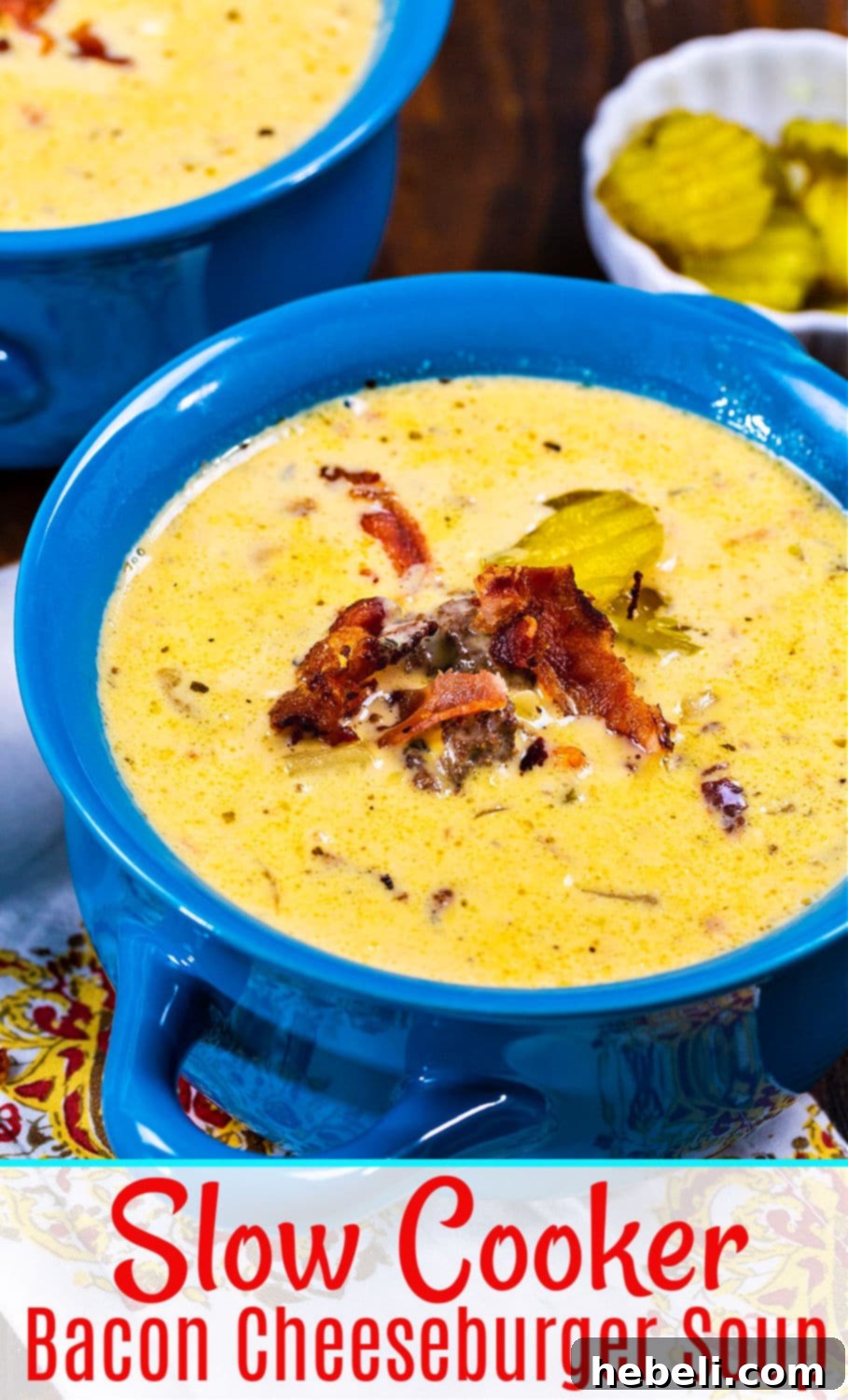 Loaded Slow Cooker Bacon Cheeseburger Soup 6 A close-up shot of a steaming bowl of Slow Cooker Bacon Cheeseburger Soup, garnished with crispy bacon and herbs, ready to be enjoyed.