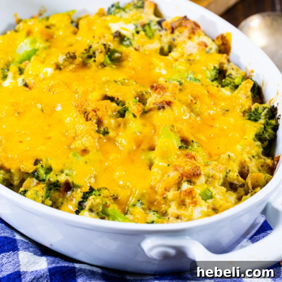 Golden brown Stove Top Broccoli Casserole in a white baking dish, fresh out of the oven, with steam gently rising.