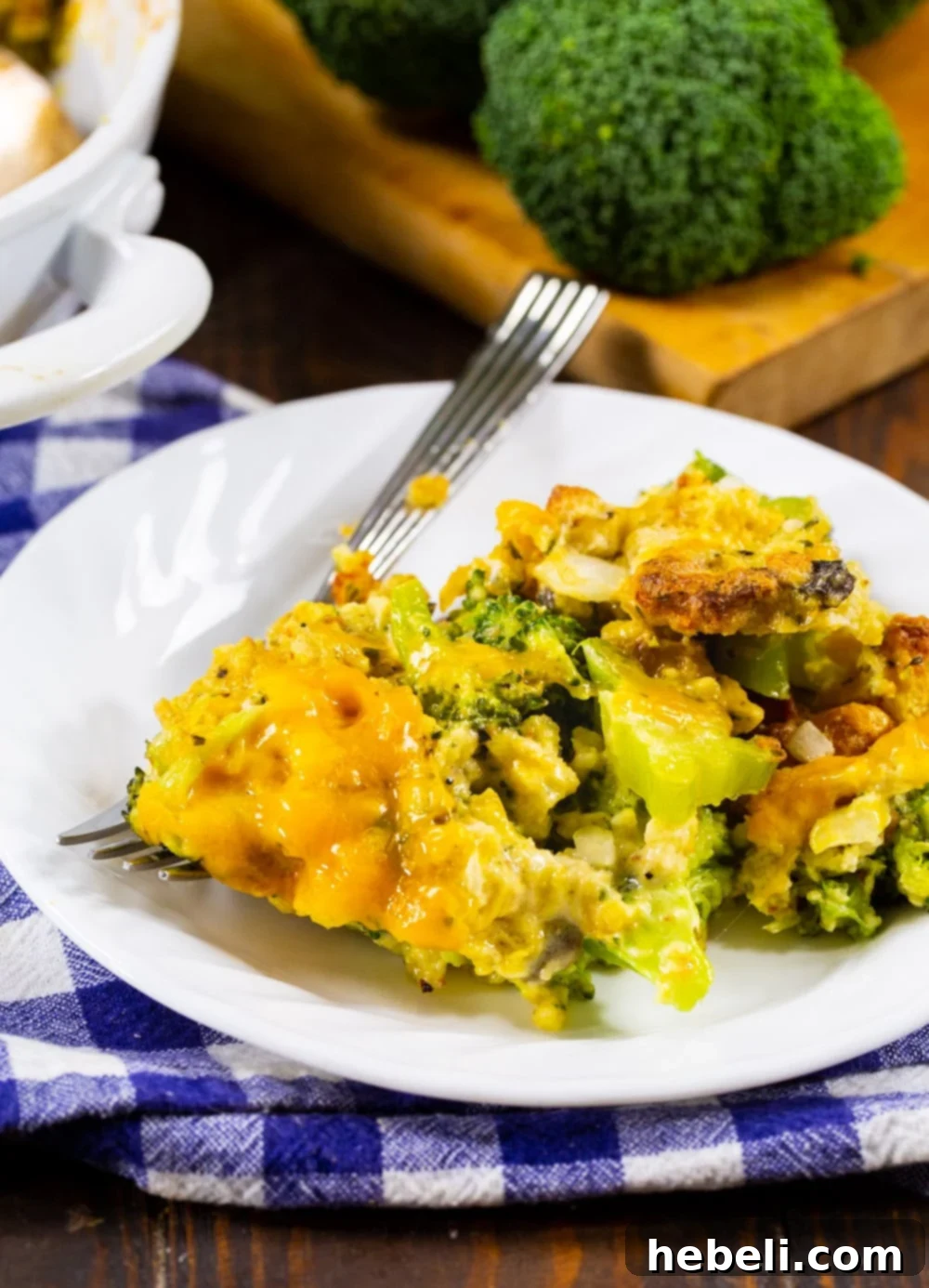 A single serving of Stove Top Broccoli Casserole on a white plate, showcasing the crispy topping and tender interior.