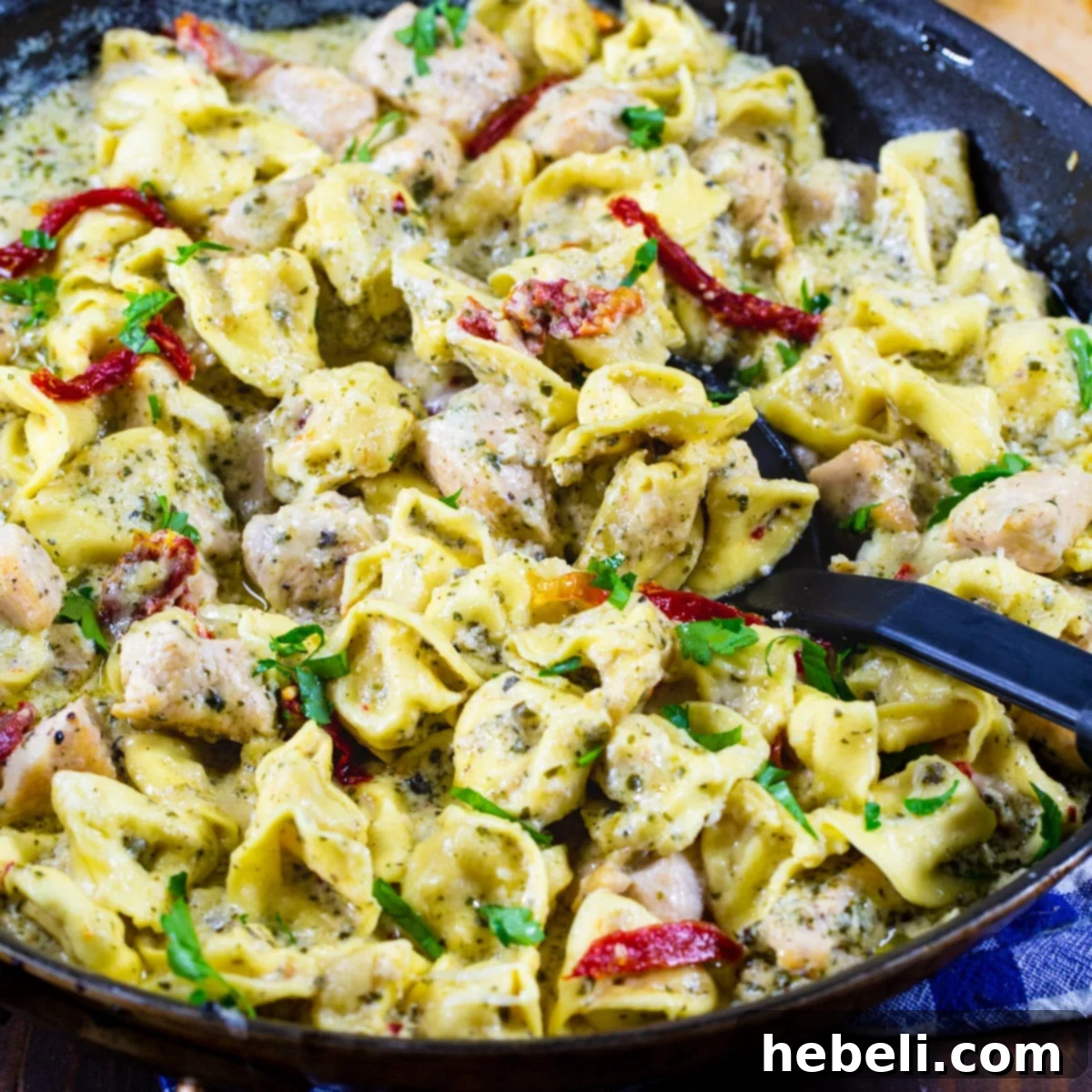 Creamy Chicken Pesto Tortellini 2 Creamy Pesto Chicken Tortellini served in a large skillet, ready for the family.
