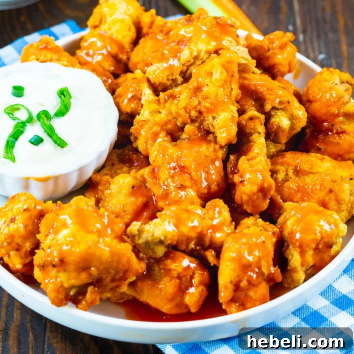 Zesty Buffalo Chicken Bites 2 Crispy Buffalo Chicken Nuggets served on a plate with creamy Blue Cheese dipping sauce, ready to be enjoyed.