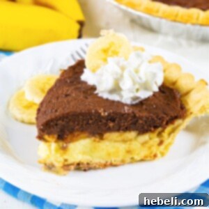 Creamy Chocolate Banana Bliss 6 A close-up shot of a perfectly plated slice of Chocolate Banana Cream Pie, adorned with a swirl of fresh whipped cream and chocolate shavings.