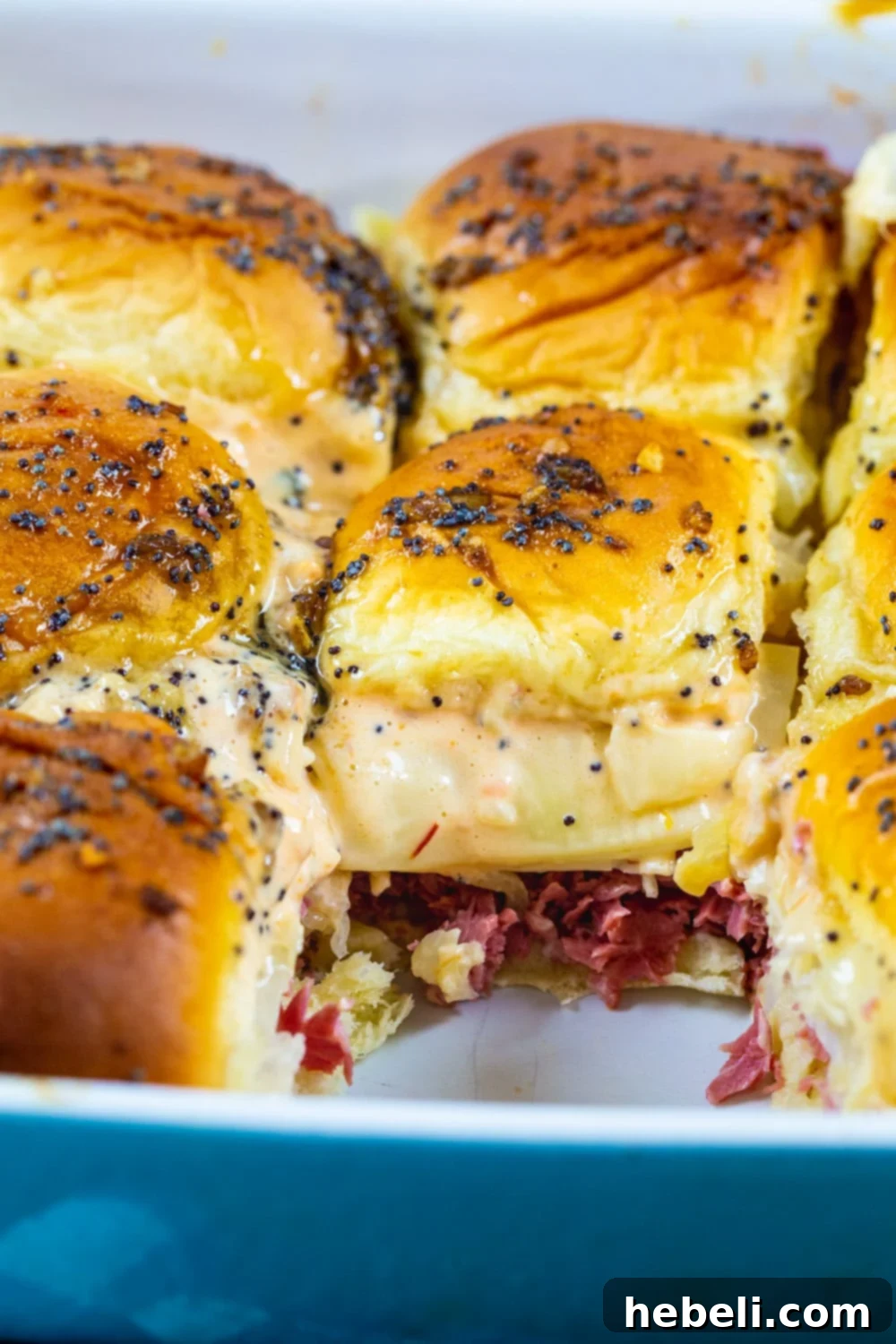 Baked Reuben Sliders arranged neatly in a 9x13 inch baking dish, ready to be served.