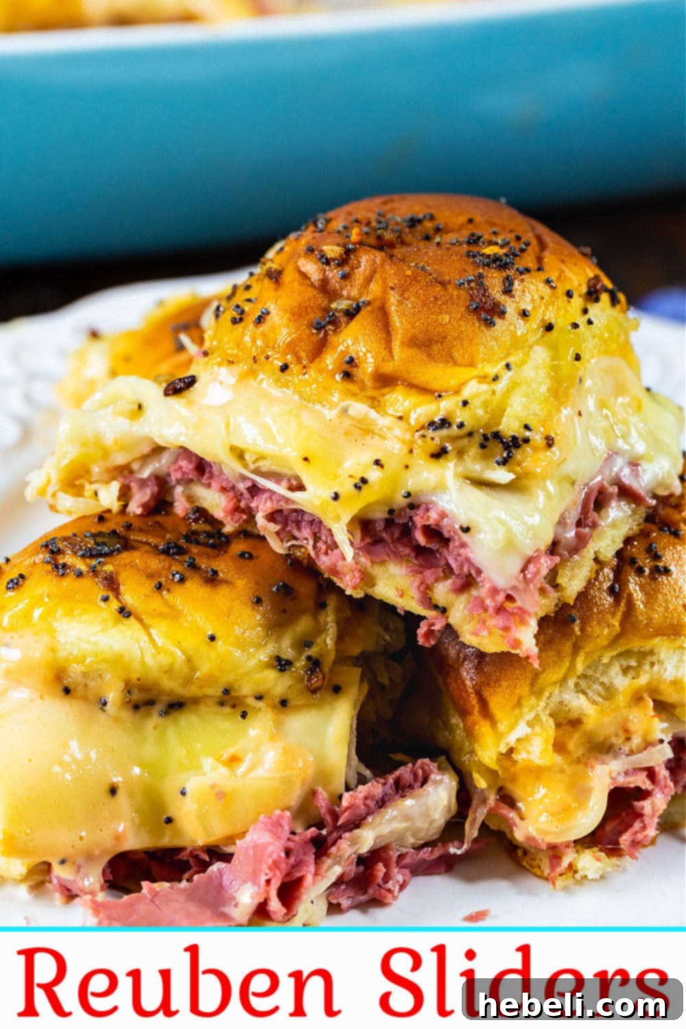 Close-up of freshly baked Reuben sliders, showing the glistening buttery topping and perfectly melted cheese.
