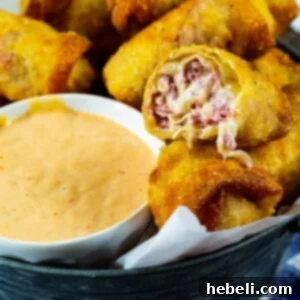 Reuben Egg Rolls with bowl full of Thousand Island Dressing.