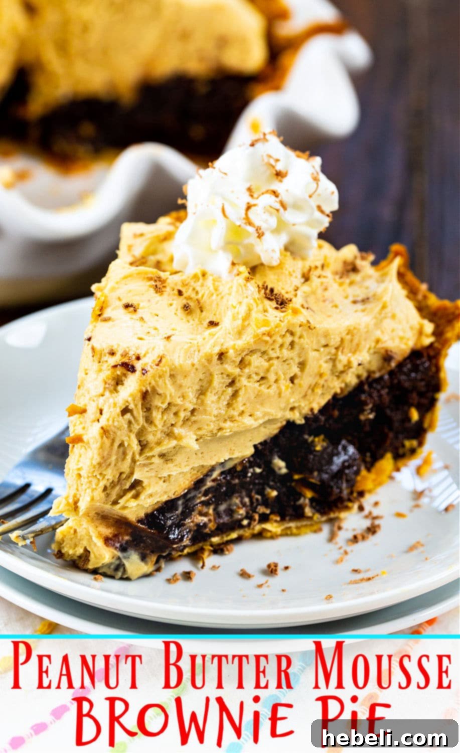 A beautifully presented Peanut Butter Mousse Brownie Pie, fully assembled and ready to be sliced, showcasing its perfect layers and inviting texture.