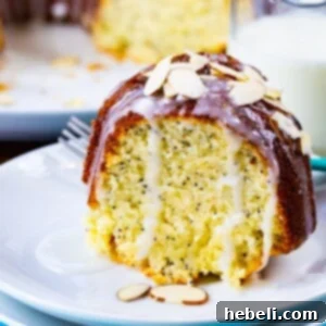 A vibrant close-up of the Almond Poppy Seed Pound Cake, perfectly glazed and ready to be served.