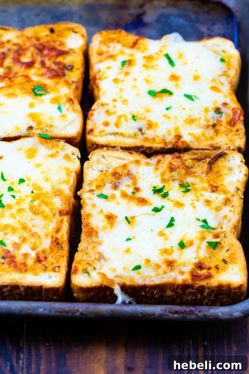 Air Fryer Cheesy Texas Toast on a baking sheet, ready to be served.