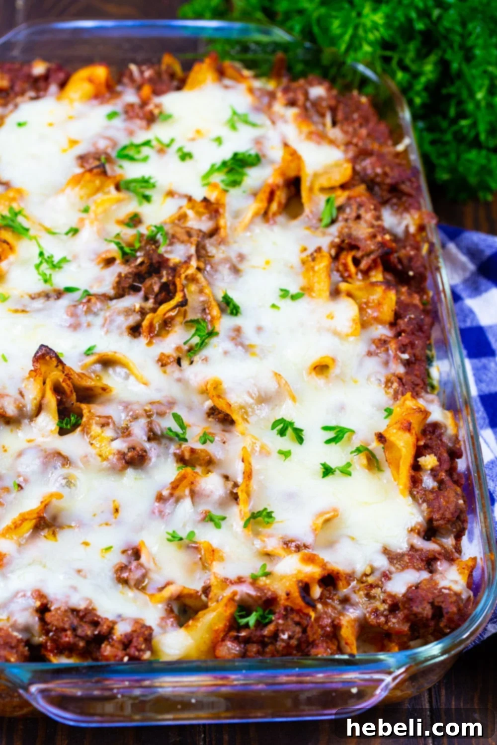 A large baking dish filled with Beef Florentine Casserole, perfectly baked with golden-brown melted cheese on top, ready to be served.
