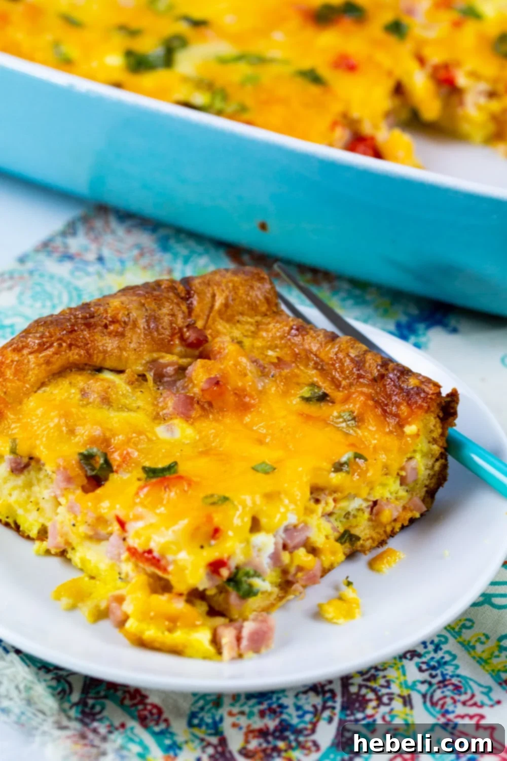 Golden Ham and Cheese Crescent Bake 7 Another slice of baked Ham and Cheese Crescent Casserole on a white plate, ready to be enjoyed.