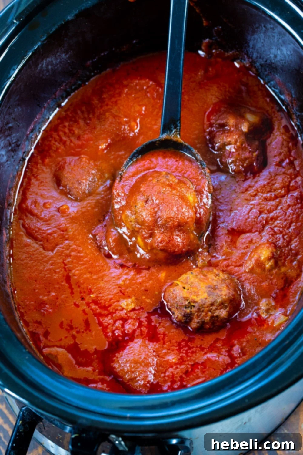 Spicy Meatballs and Marinara sauce simmering perfectly in a slow cooker.