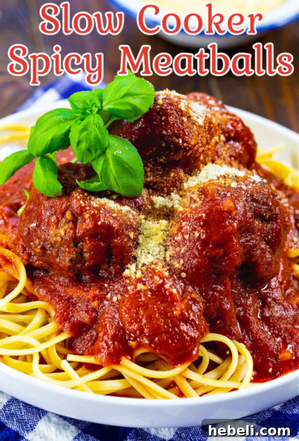 Close-up of Slow Cooker Spicy Meatballs and Marinara on spaghetti, ready to be enjoyed.