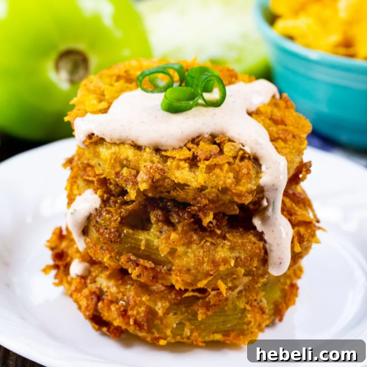 Stack of Cornflake Crusted Fried Green Tomatoes topped with Chipotle Mayo.