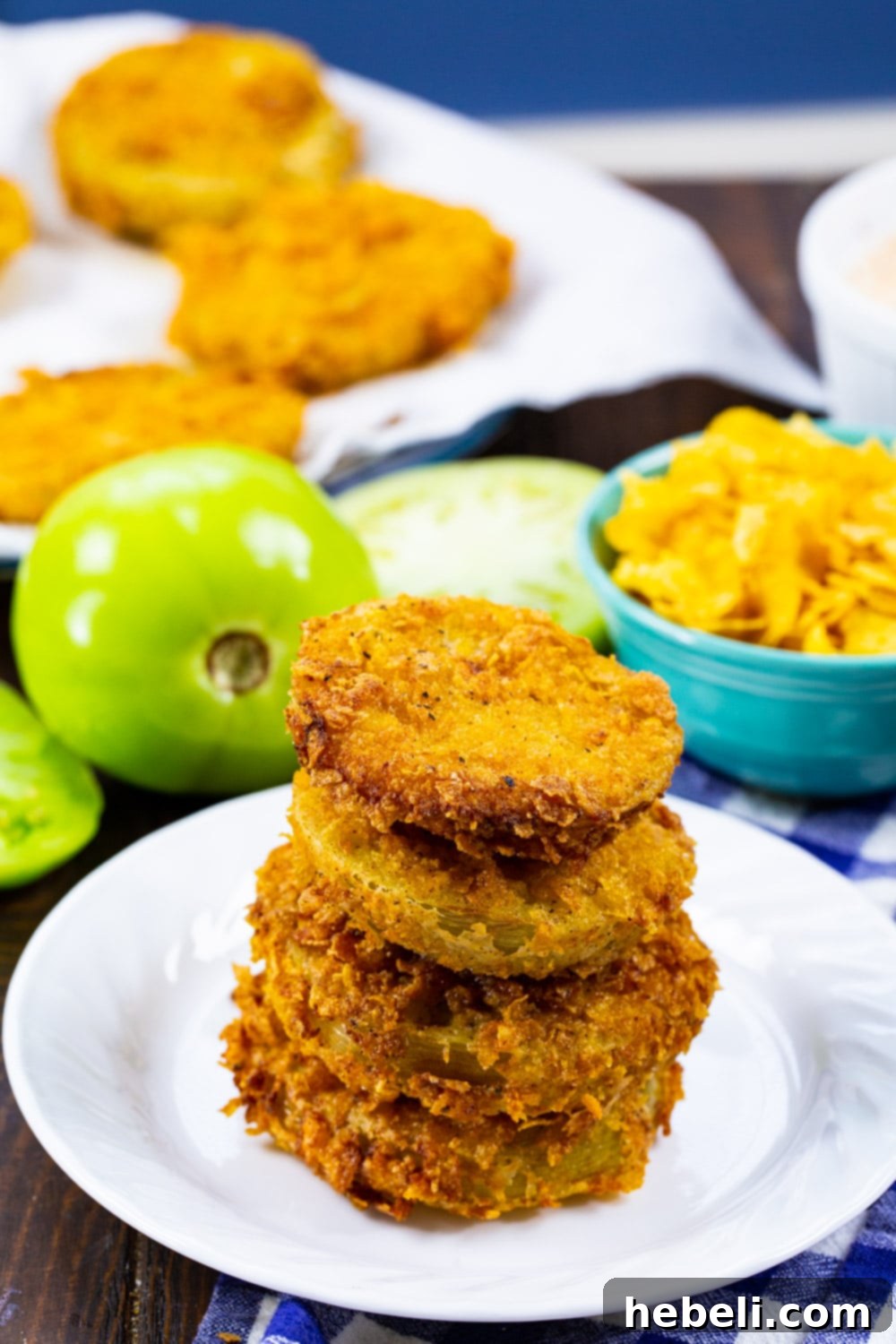 Stack of fried green tomatoes on a plate, ready to be served with chipotle ranch.