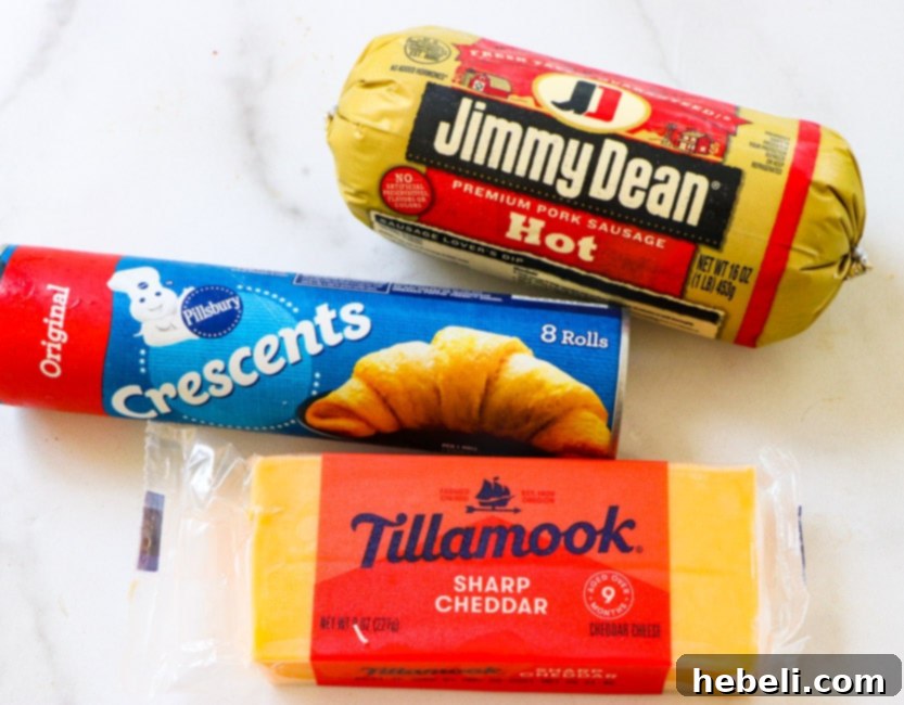 Essential ingredients for making sausage crescent balls: a package of crescent rolls, shredded cheddar cheese, and breakfast sausage.
