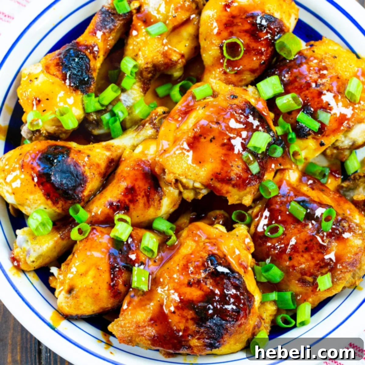 Hot Honey Chicken on a large serving plate, garnished with fresh herbs.