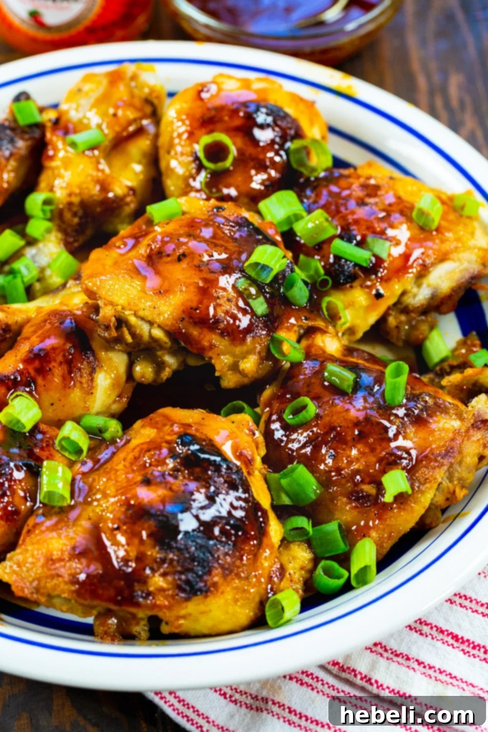 Cooked Hot Honey Chicken topped with bright green onions.
